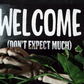 Welcome Don't Expect Much Entryway Sign